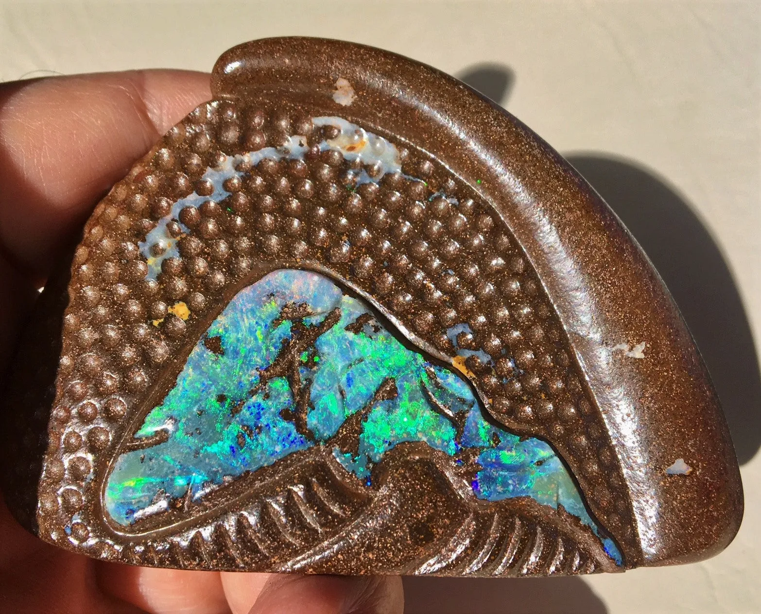 Green multi coloured carved boulder opal polished speciman